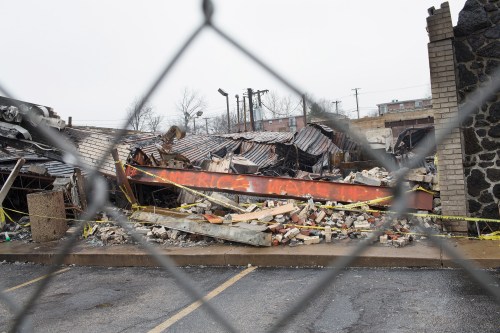 FERGUSON, MO - MARCH 13: A fence surrounds the burned rubble of a strip mall on March 13, 2015 in Ferguson, Missouri. The mall was looted and set on fire in November when rioting broke out after residents learned that the police officer responsible for the killing of Michael Brown would not be charged with any crime. Few of the businesses destroyed in the rioting in Ferguson and nearby Dellwood have reopened. Two police officers were shot Wednesday while standing outside the Ferguson police station observing a protest. Ferguson has faced many violent protests since the August death of Michael Brown. (Photo by Scott Olson/Getty Images)